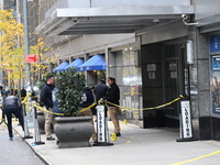 NYPD police mark evidence found at the scene with evidence markers as CEO of UnitedHealthcare Brian Thompson, 50, is shot and killed as he e...