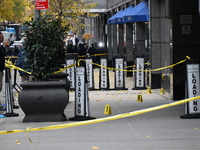 NYPD police mark evidence found at the scene with evidence markers as CEO of UnitedHealthcare Brian Thompson, 50, is shot and killed as he e...