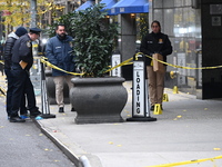 NYPD police mark evidence found at the scene with evidence markers as CEO of UnitedHealthcare Brian Thompson, 50, is shot and killed as he e...