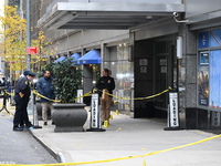 NYPD police mark evidence found at the scene with evidence markers as CEO of UnitedHealthcare Brian Thompson, 50, is shot and killed as he e...