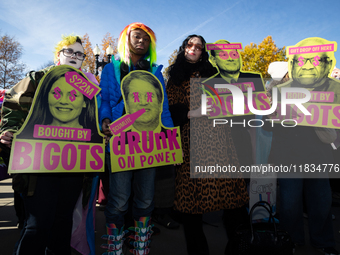 People with signs accusing Supreme Court justices of misconduct take part in a demonstration outside the Court as it hears a case on gender-...