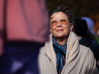 Actor Annette Bening waits as she is introduced to speak at a demonstration outside the Supreme Court, while it hears a case on gender-affir...