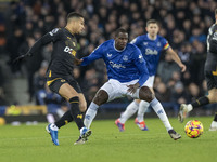 Joao Gomes #8 of Wolverhampton Wanderers F.C. is tackled by Abdoulaye Doucoure #16 of Everton F.C. during the Premier League match between E...