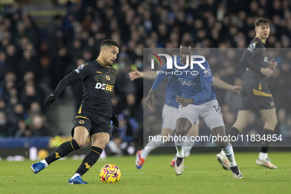 Joao Gomes #8 of Wolverhampton Wanderers F.C. is tackled by Abdoulaye Doucoure #16 of Everton F.C. during the Premier League match between E...