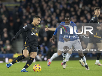 Joao Gomes #8 of Wolverhampton Wanderers F.C. is tackled by Abdoulaye Doucoure #16 of Everton F.C. during the Premier League match between E...