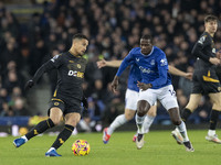 Joao Gomes #8 of Wolverhampton Wanderers F.C. is tackled by Abdoulaye Doucoure #16 of Everton F.C. during the Premier League match between E...