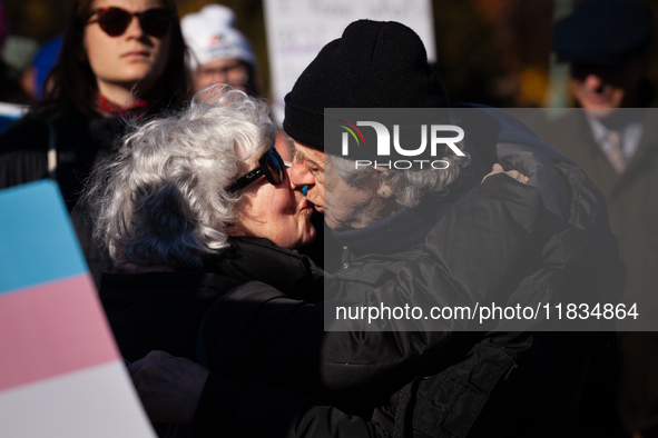 Two people meet with a kiss at a demonstration in support of gender-affirming care for transgender children, while the Supreme Court hears a...