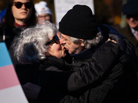 Two people meet with a kiss at a demonstration in support of gender-affirming care for transgender children, while the Supreme Court hears a...