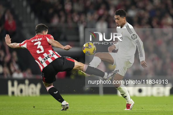 Jude Bellingham central midfield of Real Madrid and England and Dani Vivian centre-back of Athletic Club and Spain compete for the ball duri...