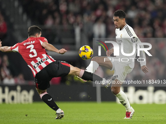 Jude Bellingham central midfield of Real Madrid and England and Dani Vivian centre-back of Athletic Club and Spain compete for the ball duri...