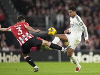 Jude Bellingham central midfield of Real Madrid and England and Dani Vivian centre-back of Athletic Club and Spain compete for the ball duri...