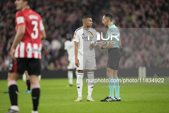 Kylian Mbappe centre-forward of Real Madrid and France talks with referee Jose Maria Sanchez Martinez during the La Liga match between Athle...