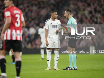 Kylian Mbappe centre-forward of Real Madrid and France talks with referee Jose Maria Sanchez Martinez during the La Liga match between Athle...