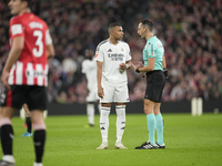 Kylian Mbappe centre-forward of Real Madrid and France talks with referee Jose Maria Sanchez Martinez during the La Liga match between Athle...