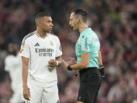 Kylian Mbappe centre-forward of Real Madrid and France talks with referee Jose Maria Sanchez Martinez during the La Liga match between Athle...