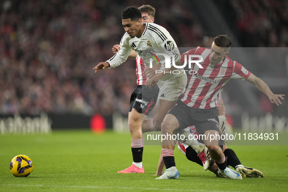 Jude Bellingham central midfield of Real Madrid and England surrounded by Athletic players during the La Liga match between Athletic Club an...