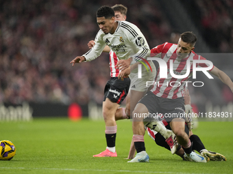 Jude Bellingham central midfield of Real Madrid and England surrounded by Athletic players during the La Liga match between Athletic Club an...