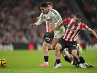 Jude Bellingham central midfield of Real Madrid and England surrounded by Athletic players during the La Liga match between Athletic Club an...