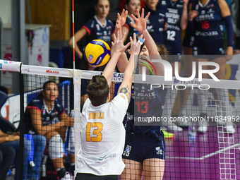 Number 13, Giulia Melli of SMI Roma Volley, and number 13, Lucille Giquel of Chieri '76, are in action during the Serie A1 Tigota match betw...