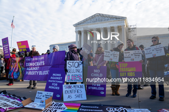 Supporters and opponents of gender-affirming care for transitioning minors are outside the Supreme Court in Washington, D.C., United States,...