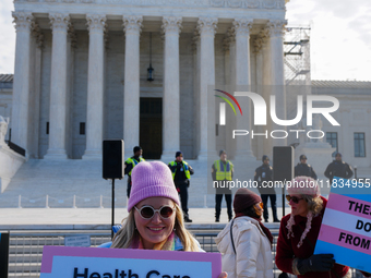 Supporters and opponents of gender-affirming care for transitioning minors are outside the Supreme Court in Washington, D.C., United States,...