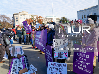 Supporters and opponents of gender-affirming care for transitioning minors are outside the Supreme Court in Washington, D.C., United States,...