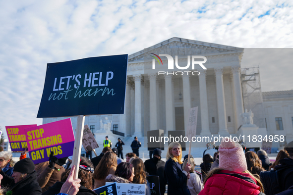 Supporters and opponents of gender-affirming care for transitioning minors are outside the Supreme Court in Washington, D.C., United States,...