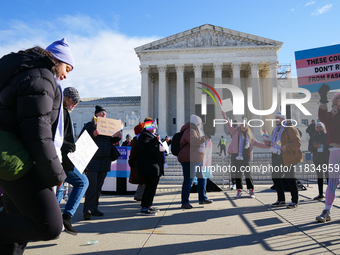 Supporters and opponents of gender-affirming care for transitioning minors are outside the Supreme Court in Washington, D.C., United States,...