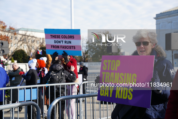 Supporters and opponents of gender-affirming care for transitioning minors are outside the Supreme Court in Washington, D.C., United States,...