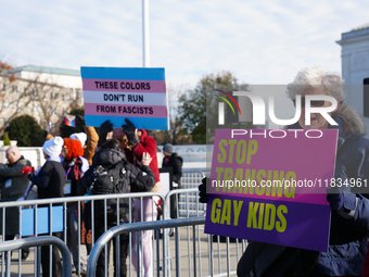 Supporters and opponents of gender-affirming care for transitioning minors are outside the Supreme Court in Washington, D.C., United States,...