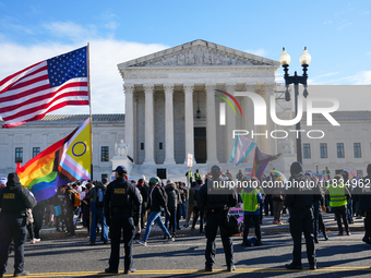 Supporters and opponents of gender-affirming care for transitioning minors are outside the Supreme Court in Washington, D.C., United States,...