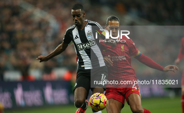 Newcastle United's Alexander Isak breaks past Liverpool's Virgil van Dijk during the Premier League match between Newcastle United and Liver...