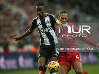 Newcastle United's Alexander Isak breaks past Liverpool's Virgil van Dijk during the Premier League match between Newcastle United and Liver...