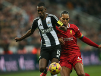 Newcastle United's Alexander Isak breaks past Liverpool's Virgil van Dijk during the Premier League match between Newcastle United and Liver...