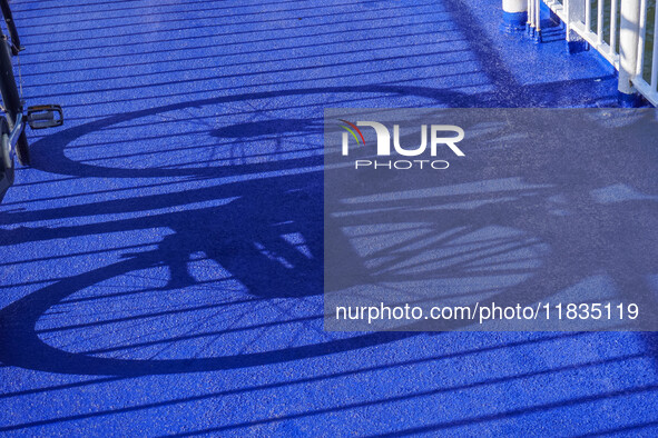 A young lady with her bicycle waits to disembark the ferry after it docks in Nordby, Fano Island, Denmark, on April 29, 2024. 