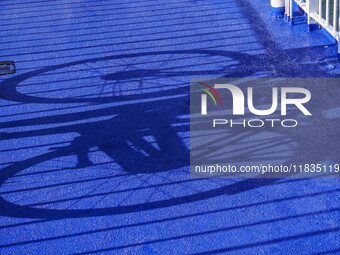 A young lady with her bicycle waits to disembark the ferry after it docks in Nordby, Fano Island, Denmark, on April 29, 2024. (