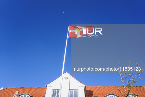 The Danish flag is seen in the wind in Nordby, Fano Island, Denmark, on April 29, 2024. 