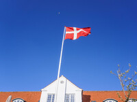 The Danish flag is seen in the wind in Nordby, Fano Island, Denmark, on April 29, 2024. (