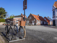 A general view of the traditional Danish houses with bicycles parked in the foreground is seen in Nordby, Fano Island, Denmark, on April 29,...