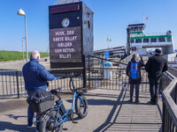 People wait for the all-electric ferry that runs between Island and Esbjerg, belonging to the Fanolinjen, in Nordby, Fano Island, Denmark, o...