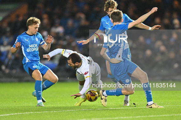 Mason Bennett (32 Burton Albion) is challenged by Oscar Wallin (5 Peterborough United) during the Sky Bet League 1 match between Peterboroug...