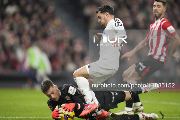 Brahim Diaz attacking midfield of Real Madrid and Spain and Julen Agirrezabala goalkeeper of Athletic Club and Spain compete for the ball du...