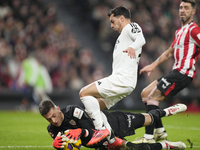 Brahim Diaz attacking midfield of Real Madrid and Spain and Julen Agirrezabala goalkeeper of Athletic Club and Spain compete for the ball du...