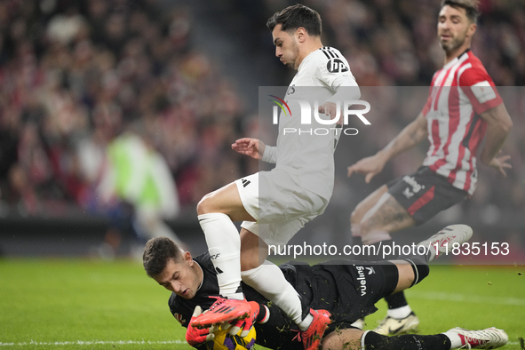 Brahim Diaz attacking midfield of Real Madrid and Spain and Julen Agirrezabala goalkeeper of Athletic Club and Spain compete for the ball du...