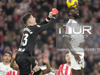 Antonio Rudiger centre-back of Real Madrid and Germany and Julen Agirrezabala goalkeeper of Athletic Club and Spain compete for the ball dur...