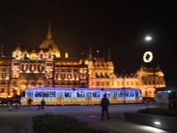 A tram decorated with Christmas lights passes in front of the Hungarian Parliament in Budapest, Hungary, on December 3, 2024.(