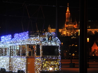 A tram decorated with Christmas lights passes in front of the Fisherman's Bastion in Budapest, Hungary, on December 4, 2024. (