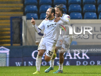 Mason Bennett (32 Burton Albion) celebrates after scoring the team's first goal with Rumarn Burrell (18 Burton Albion) during the Sky Bet Le...