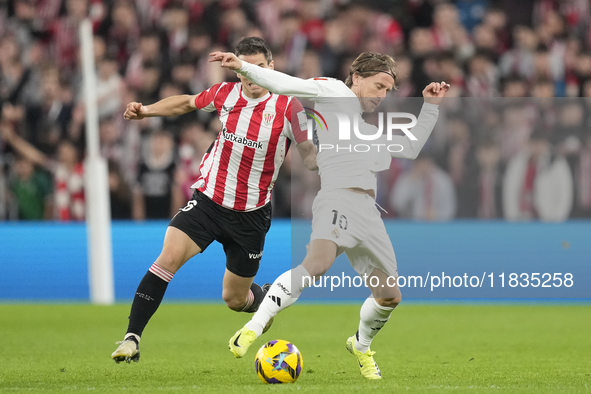 Luka Modric central midfield of Real Madrid and Croatia and Inigo Ruiz de Galarreta central midfield of Athletic Club and Spain compete for...