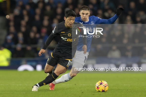 Hwang Hee-chan #11 of Wolverhampton Wanderers F.C. is tackled by Vitaliy Mykolenko #19 of Everton F.C. during the Premier League match betwe...